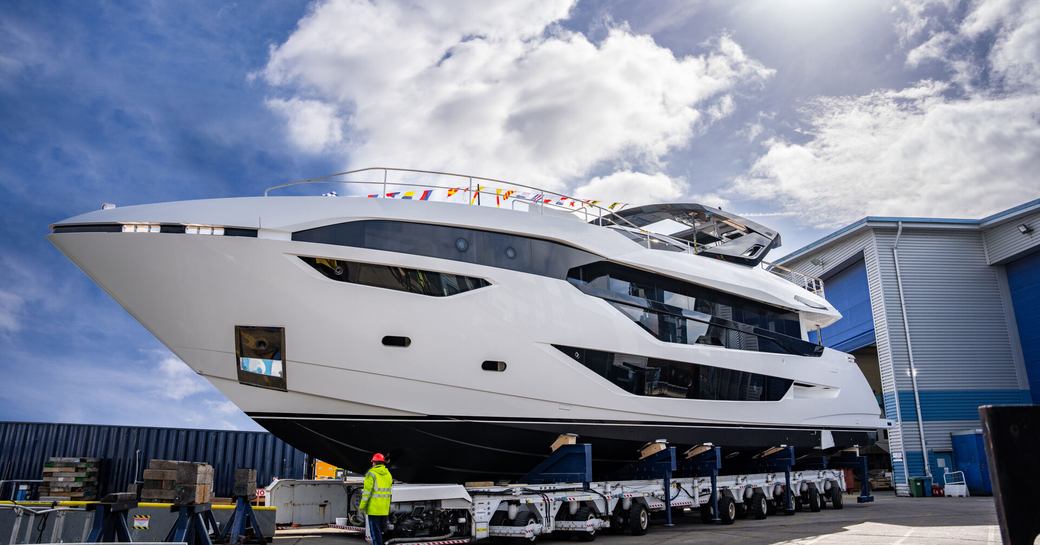 Side view of Sunseeker 100 Yacht emerging from building shed. 