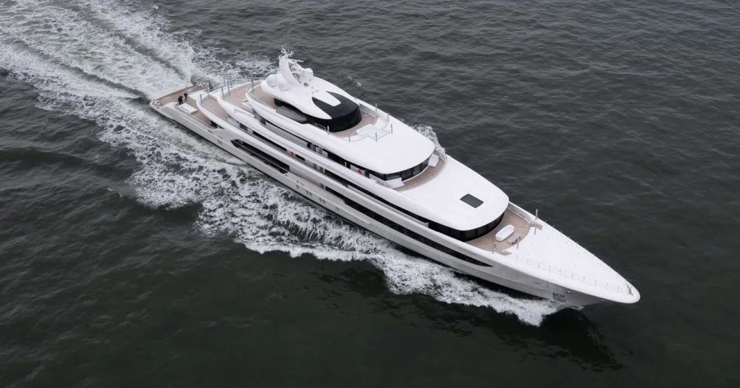 Aerial view looking down on superyacht H3 at sea.