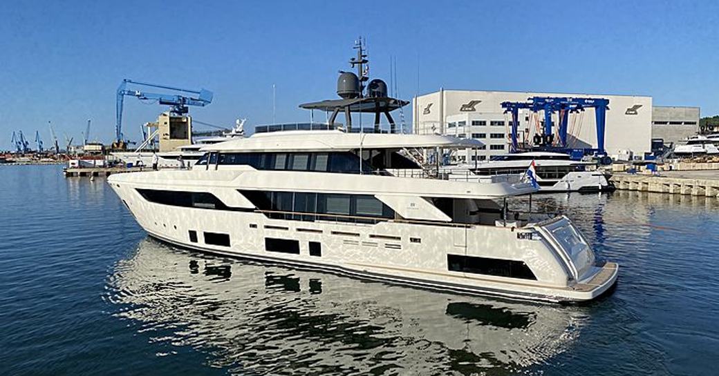 Custom Line ROMA VII leaving construction yard, surrounded by sea with reflection in water