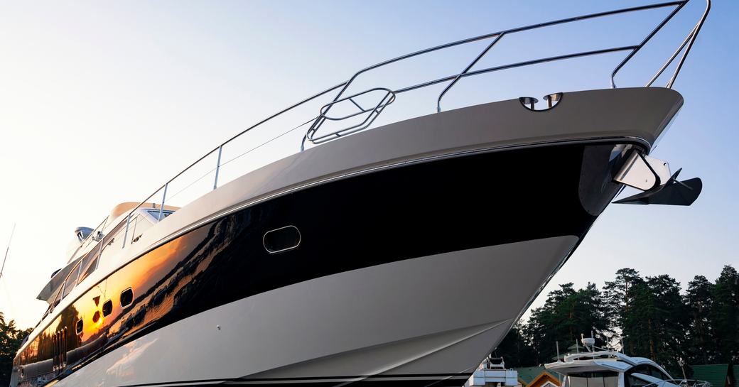 Close up view of a motor yacht bow at sunset.