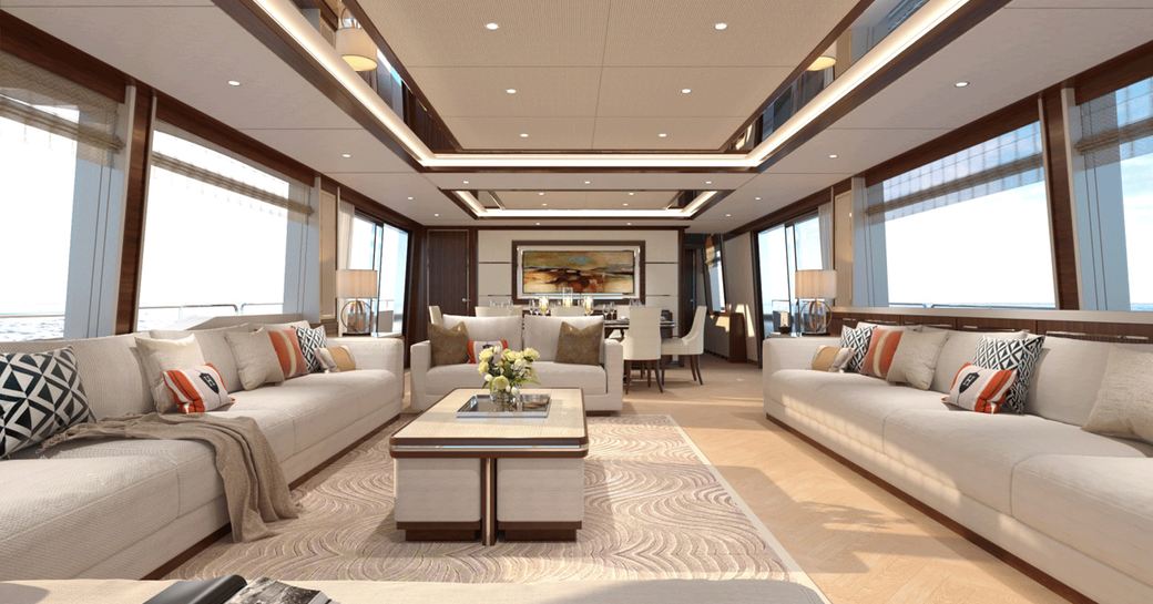 Two long beige sofas face each other with a coffee table in-between in the main salon of the Asteria 108 yacht from Heysea