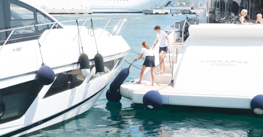 Crew on the back of a motor yacht