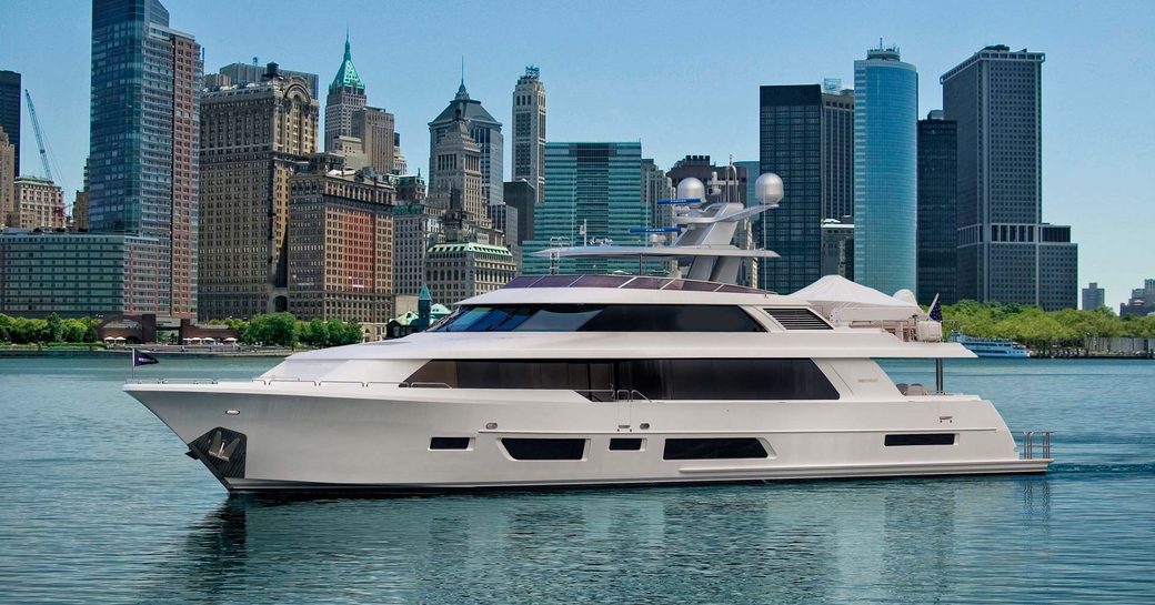 rendering of luxury yacht model westport 112 underway with cityscape skyline in background