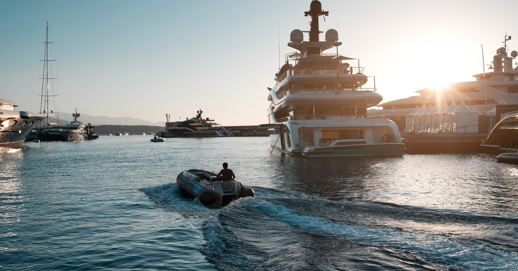 electric tender sailing past superyacht