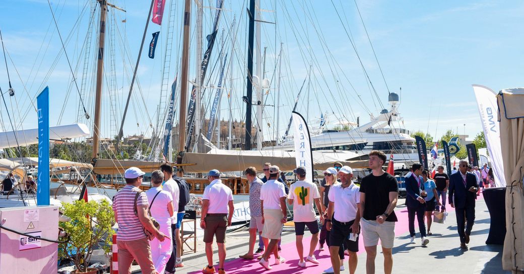 Visitors at the Palma International Boat Show walking on a red carpet in Marina Moll Vell