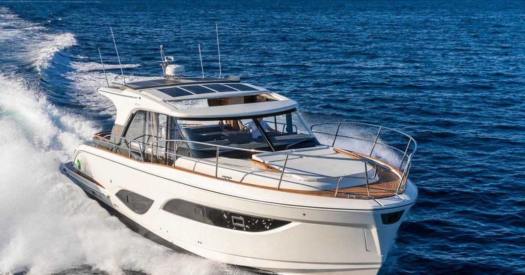 Marex 440 at Southampton International Boat Show, boat is shown in running shot, starboard bow aspect, smooth sea, bright day