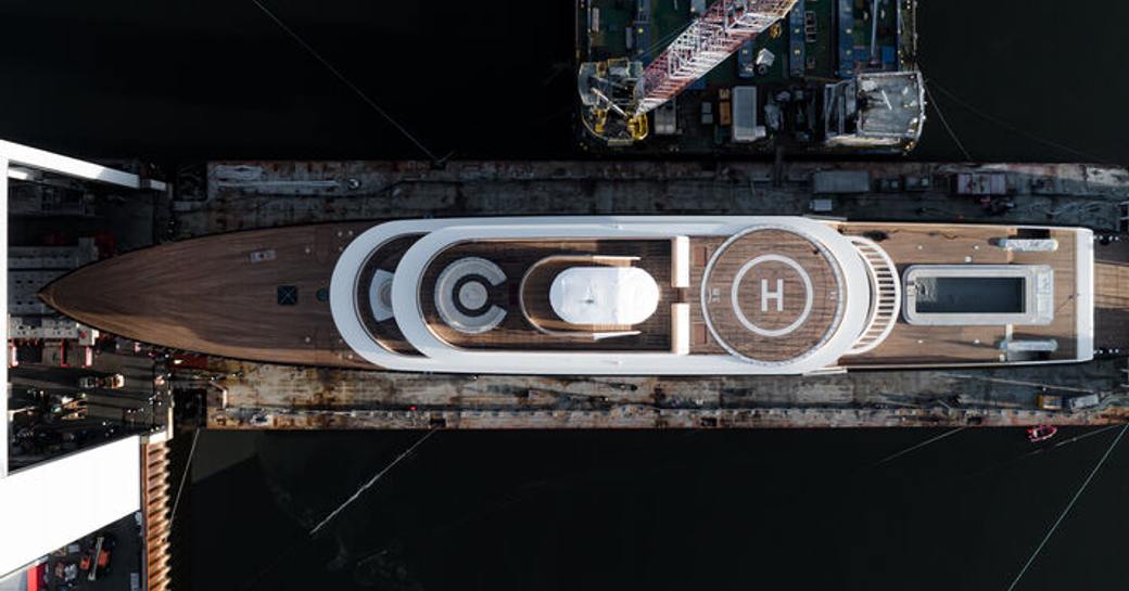 Aerial, overhead shot looking down on Abeking & Rasmussen Hull 6507. Circular helipad centre, with all decks visible.