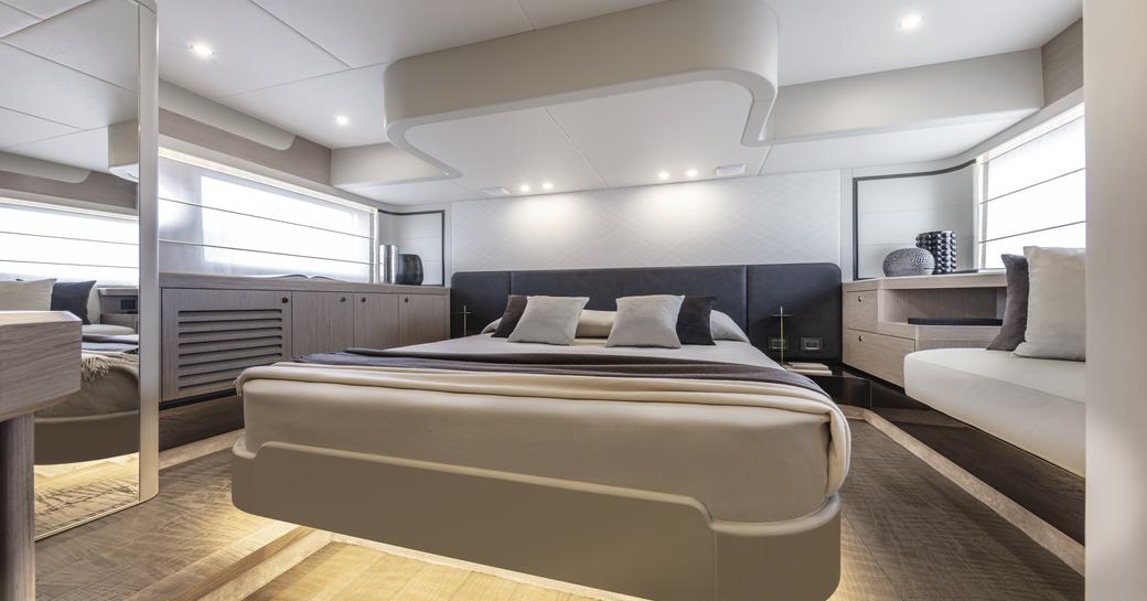 Master cabin onboard Absolute 50Fly, central berth with seating to starboard side