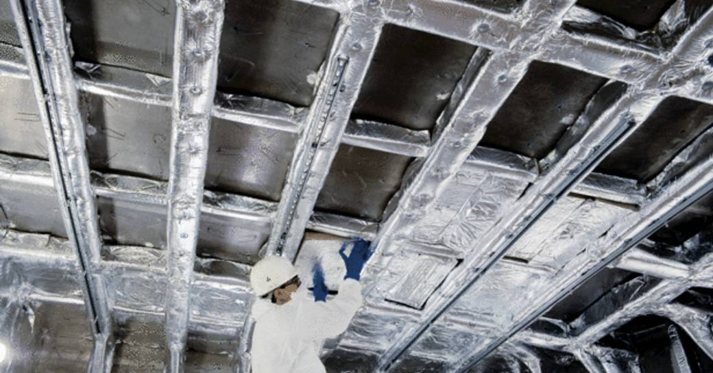 Construction worker building a ceiling onboard the third Tankoa S501 hull