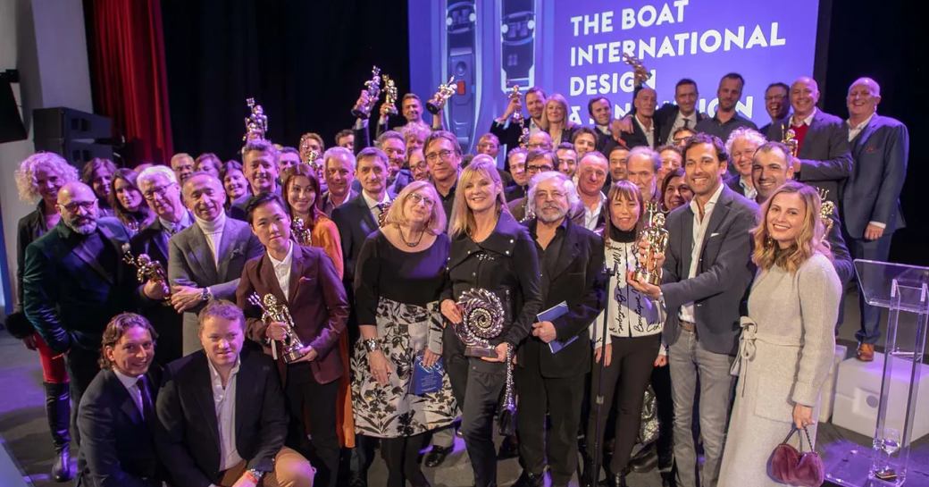 BOAT International Design & Innovation Awards 2019 - winners and judges posing by stage