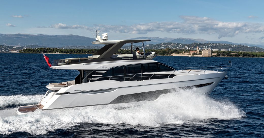 Fairline Squadron 68 Mk3 underway, surrounded by sea with land in far distance.