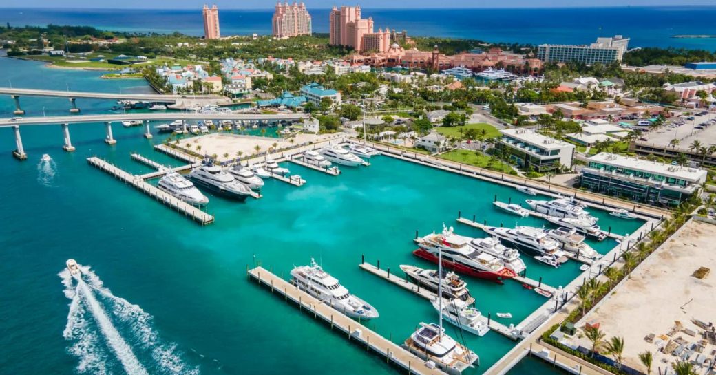 Aerial view of Hurricane Hole Superyacht Marina, many superyachts berthed with famous Atlantis hotel in background.