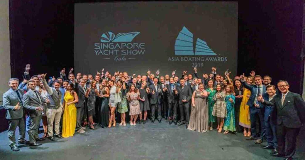 Group photo of all the winners at the 2019 Asia Boating Awards, holding up trophies.