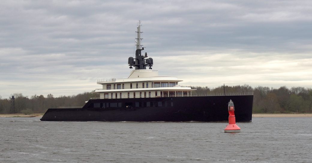 Side view of M/Y LIVA cruising by a buoy on a German river.