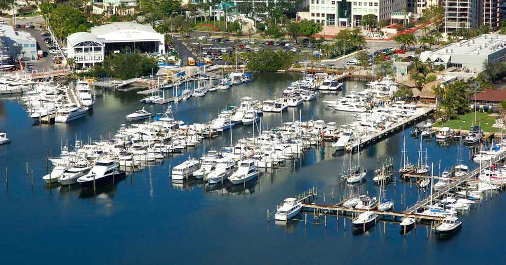 Overview of Bayshore Landing marina Miami, multiple motor yachts moored along slips, surrounded by Coconut Grove infrastructure