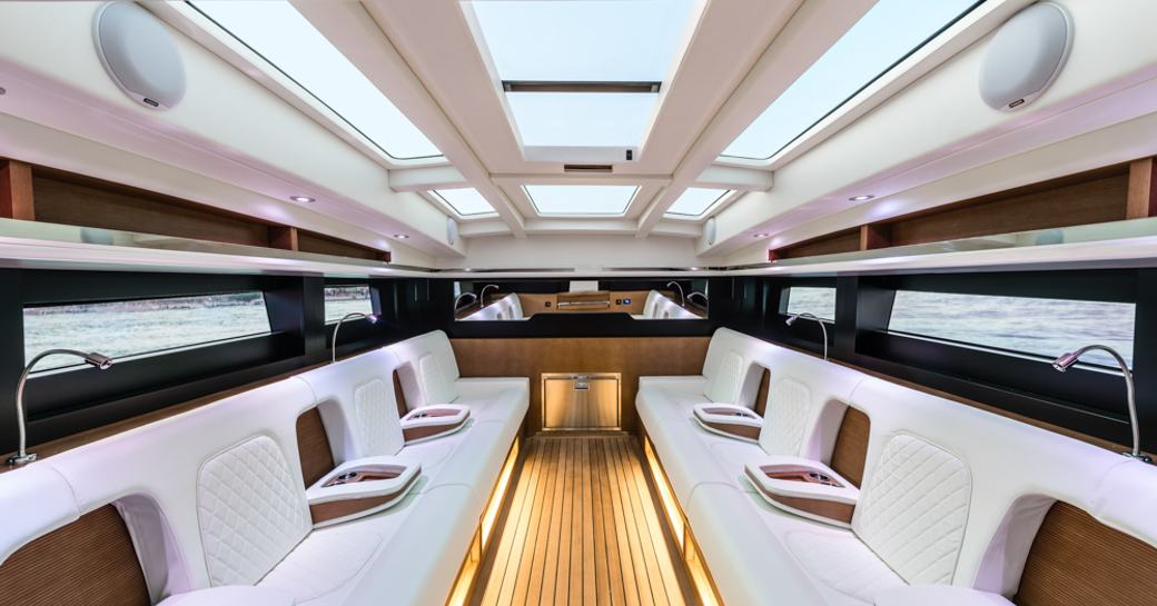 Lightly colored interior of deckhouse of Wooden Boats WB14 limousine tender. Skylight above and LED lighting.