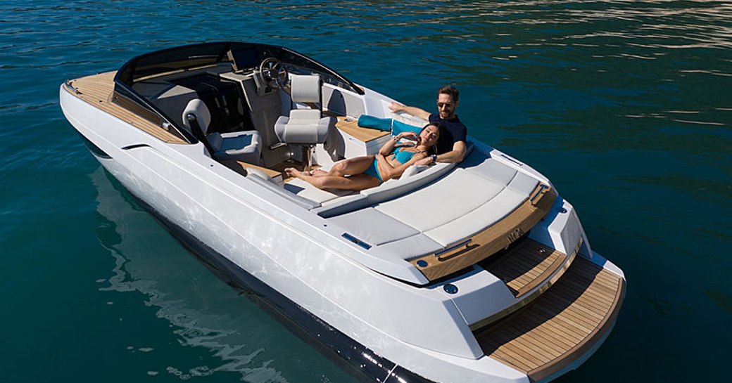 Rear view of Nerea Yachts NY24 stationary at sea with two people relaxing on aft seating