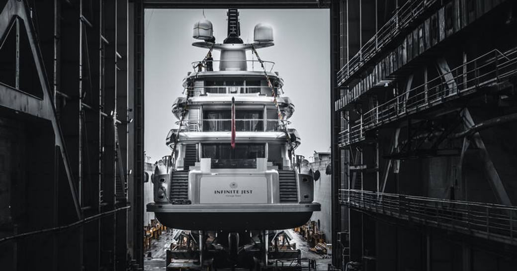 Aft view of superyacht Infinite Jest inside building shed.