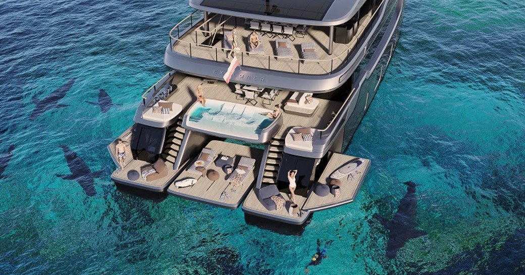 Overview of the aft decks onboard the 33m Sunreef Explorer Eco. Guests seen lounging on the swim platform, with sun loungers and seating across the decks. Surrounded by sea.