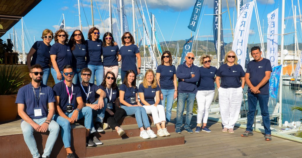 Group photo of crew members in front of Marina Moll Vell during the Palma International Boat Show