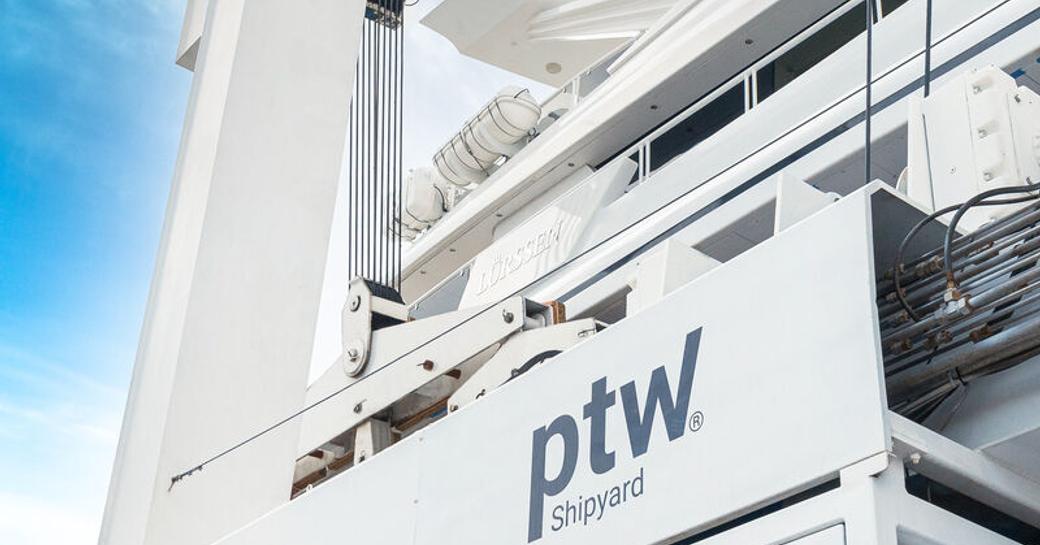 Side view close up of ptw Shipyard travel lift with a Lurssen superyacht in transit.