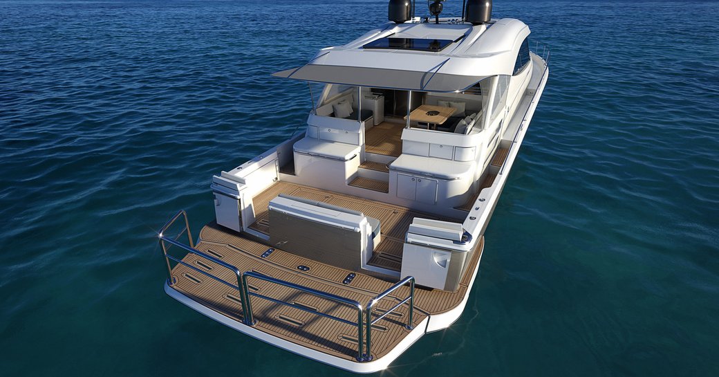 Aft view of Riviera 645 SUV, swim platform raised, with alfresco dining in background. Surrounded by sea.