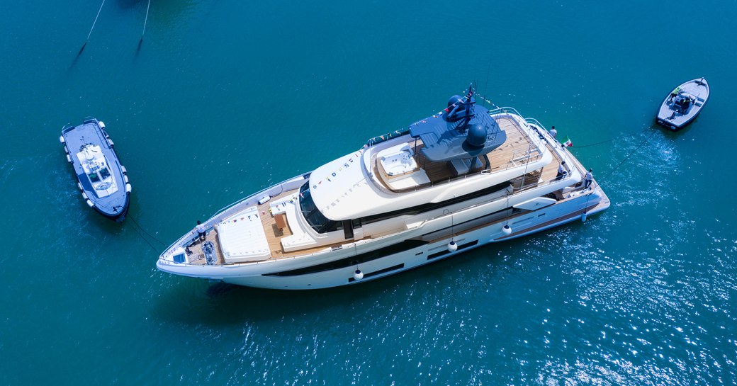 Aerial view of Custom Line Navetta 33 with two tenders at sea