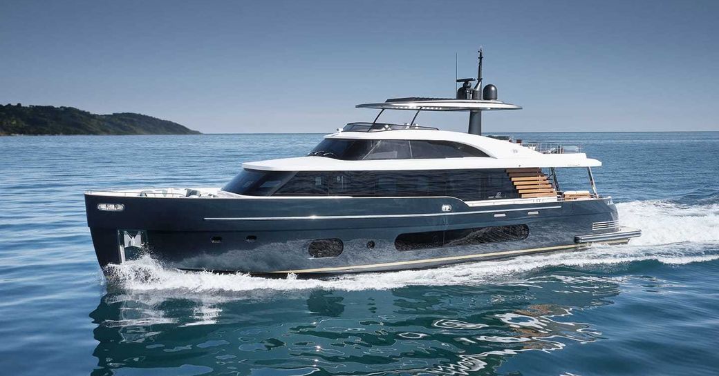 Azimut Magellano 25 Metri underway, surrounded by sea and rock formations in background