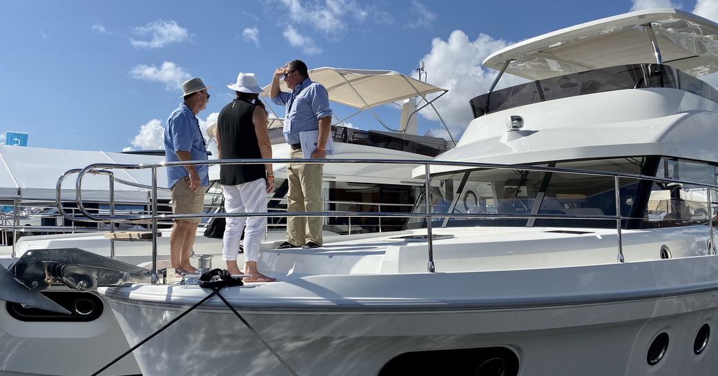 couple on deck looking at a yacht 