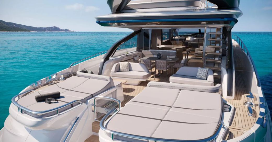 Aft deck onboard Princess S80. Large duo of sunpads in foreground with alfresco lounge area aft. Yacht is surrounded by sea.