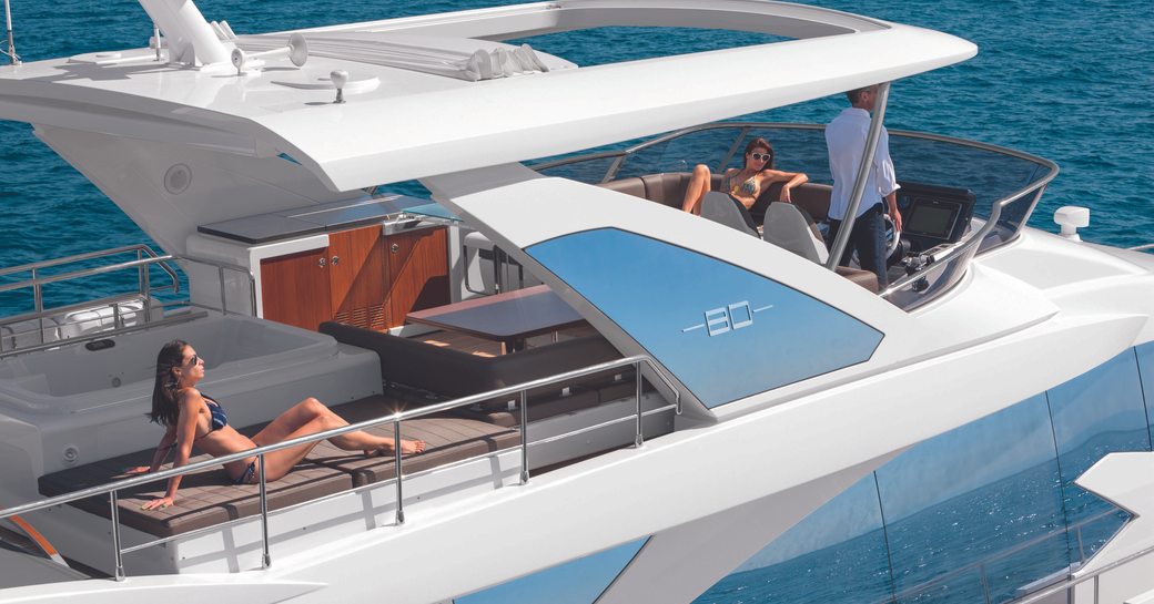 Yacht charter guests relaxing on the flybridge of an 80ft Azimut motor yacht