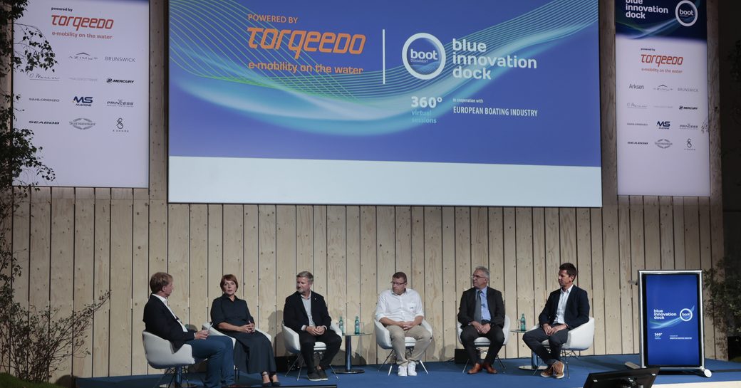 Overview of the Blue Innovation Dock conference at Boot Dusseldorf. Panelists sat on stage in discussion.