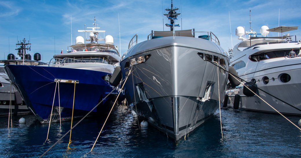 A lineup of superyacht bows berthed at the Monaco Yacht Show