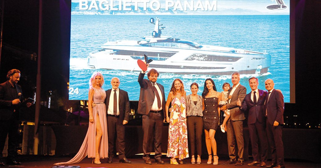 Line up of winners on stage at the World Yachts Trophies, with the screen in the background readin Best Innovation Baglietto PANAM