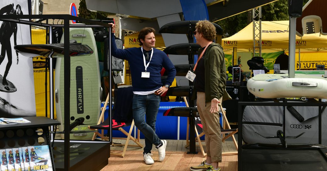 Exhibitors in a stand for water toys in discussion at the Palma International Boat Show