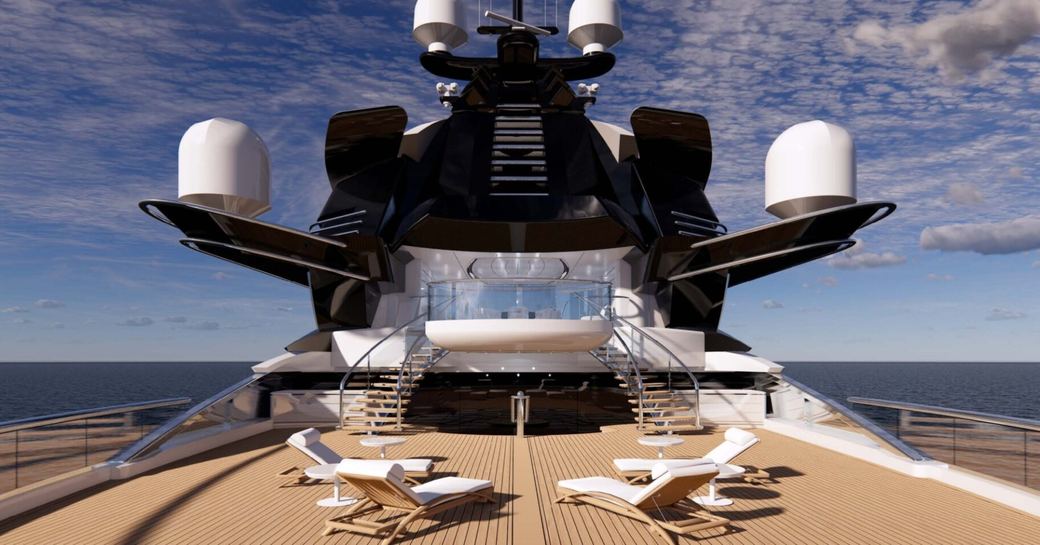 the aft upper deck area of KISMET is shown with sun loungers on a bright sunny day