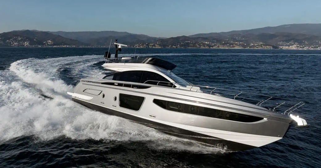 Running shot of Azimut S7 underway, with land in far distance in background.