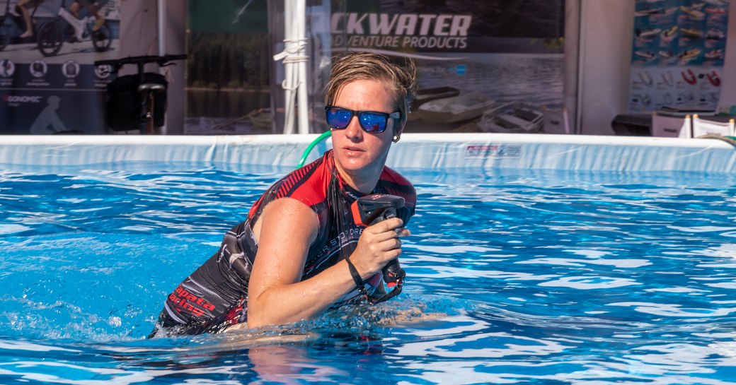 Female watertoys demonstrator in pool at FLIBS