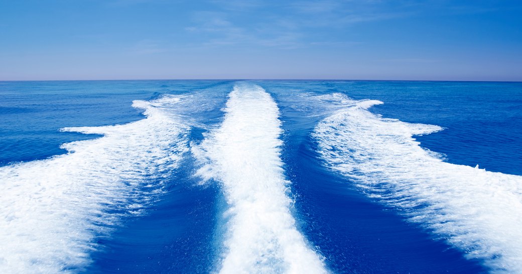 boat wake yacht wash open waters blue sky