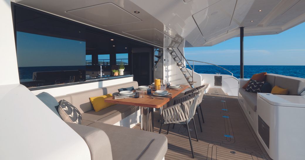 The aft lounge boasts comfortable seating and expansive views out to sea