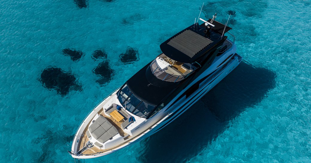 Bird's eye view looking down on Sunseeker 88 Yacht, surrounded by water.