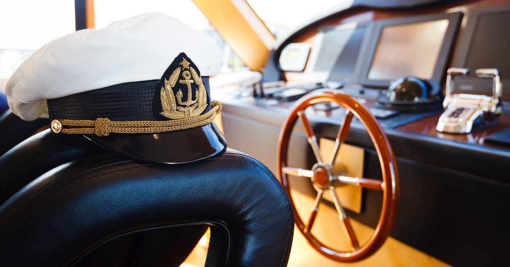 Captain's hat on seat in front of helm console