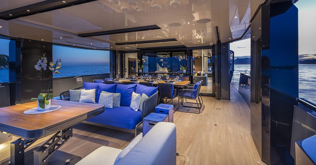 Aft deck area with comforable seating and tables and open sides