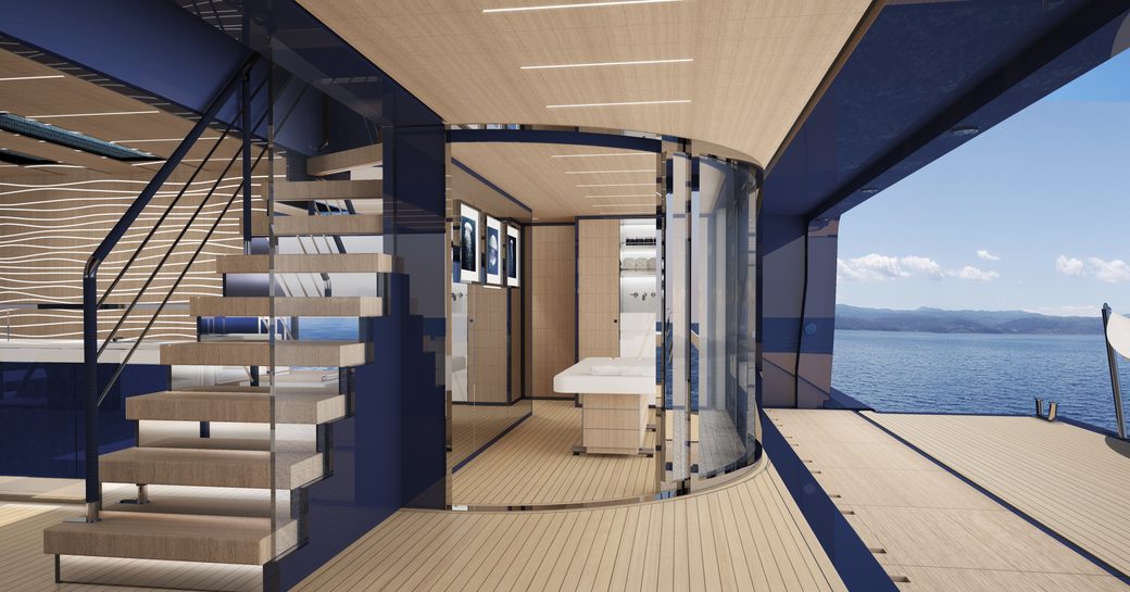 View across wooden decking of ISA Classic superyacht, with stairs on left hand side of photo and massage table in glass room room straight ahead.