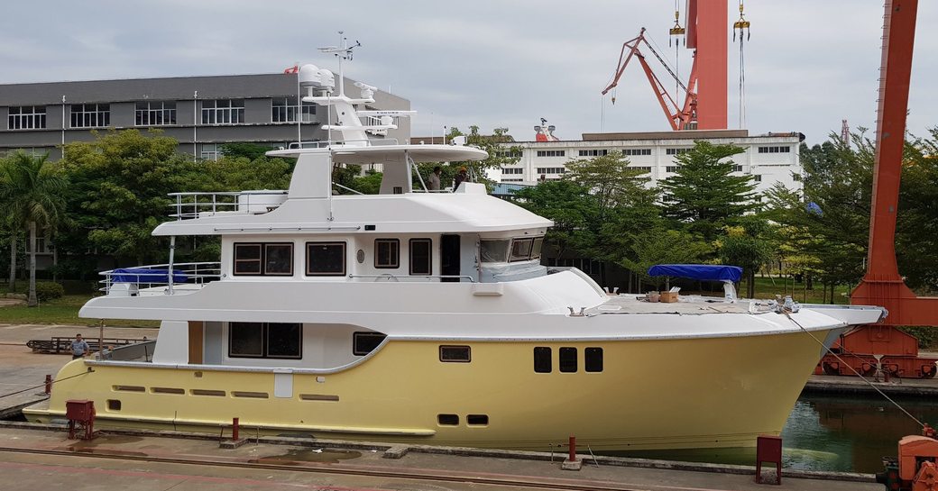 Nordhavn N80 on water with houses in background