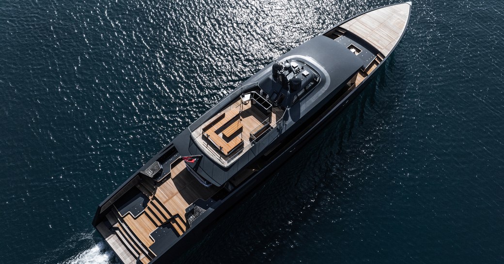 Alia Yachts SAN 45m yahcht in aerial shot over starboard side, running shot as wake being created, calm sea