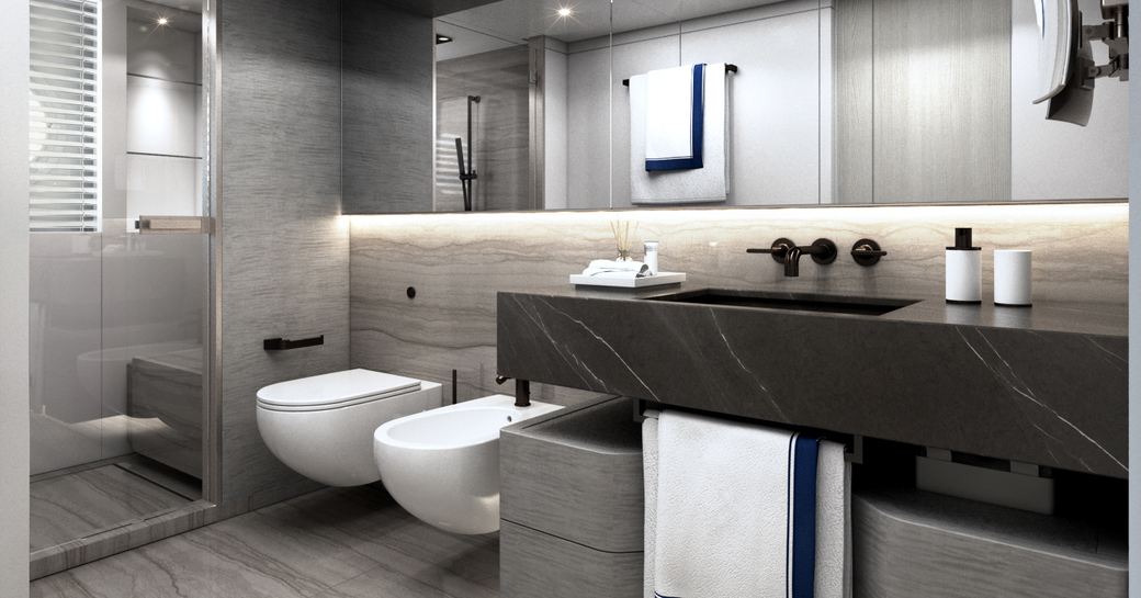 Lightly colored bathroom, with toilet, bidet and sink visible, and long mirror on wall