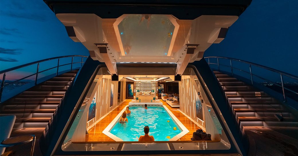 Beach club lit up at night on superyacht TATIANA