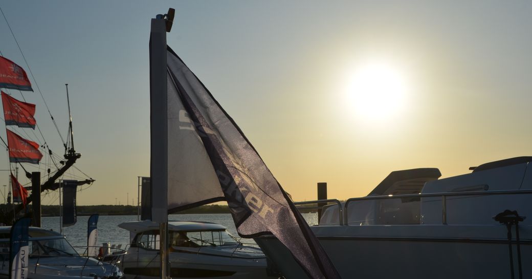 Sunseeker flag in foreground with yacht in background