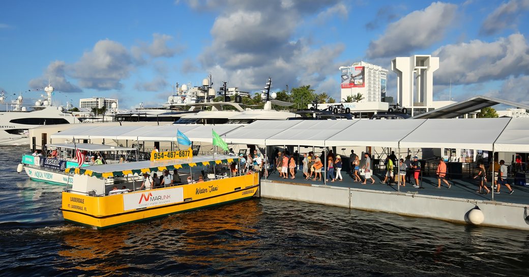 Crowds on pontoons at Fort Lauderdale with water taxi in foreground